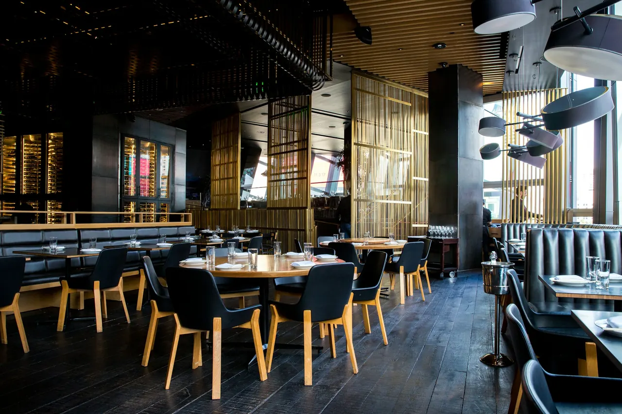 The Norqavi Dining Room, with dark tables, timber panelling and pendant lighting