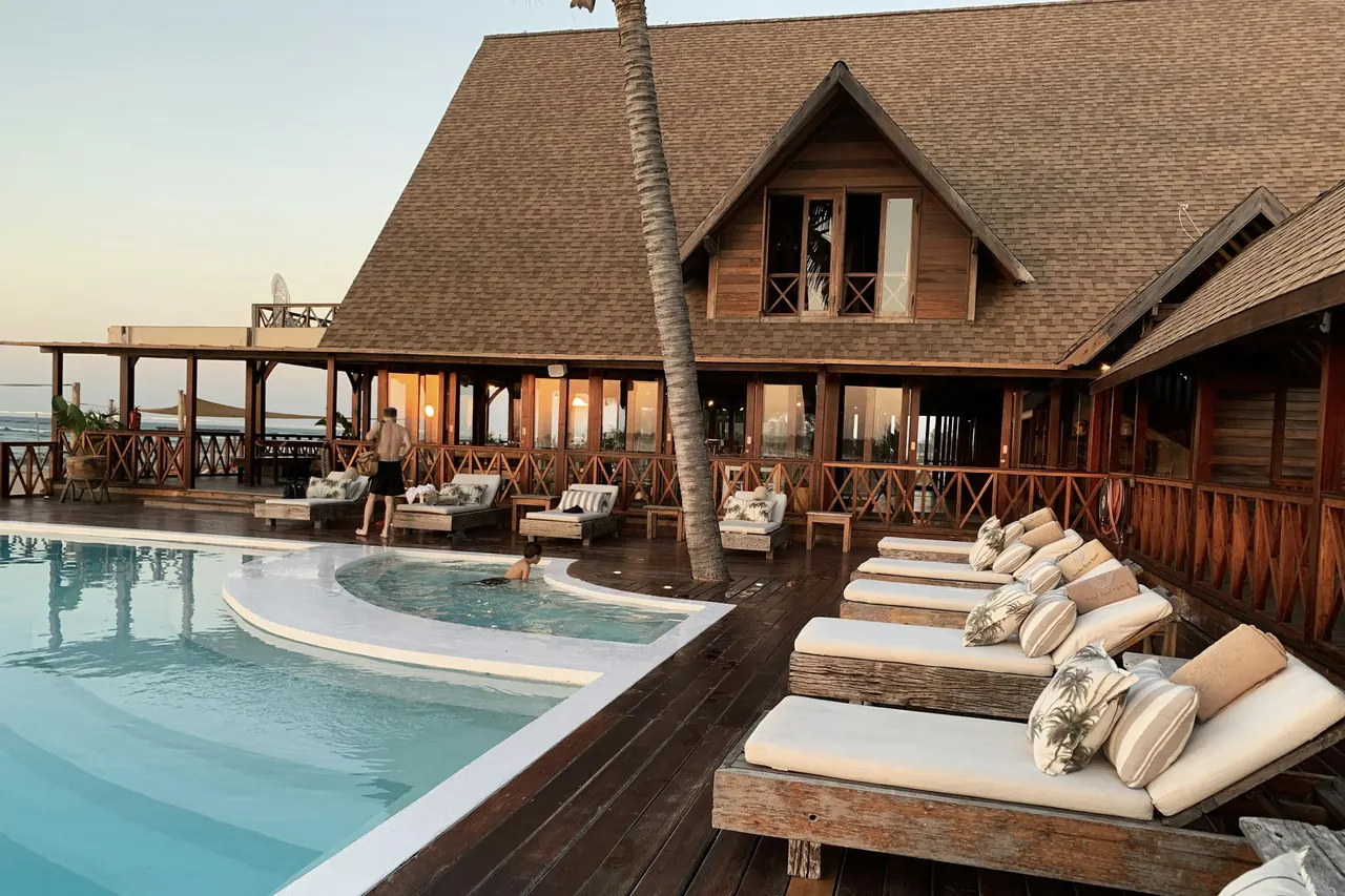 Sun loungers beside a calm pool in the late afternoon