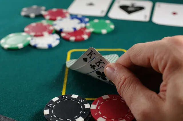 Cards and chips on a green casino table